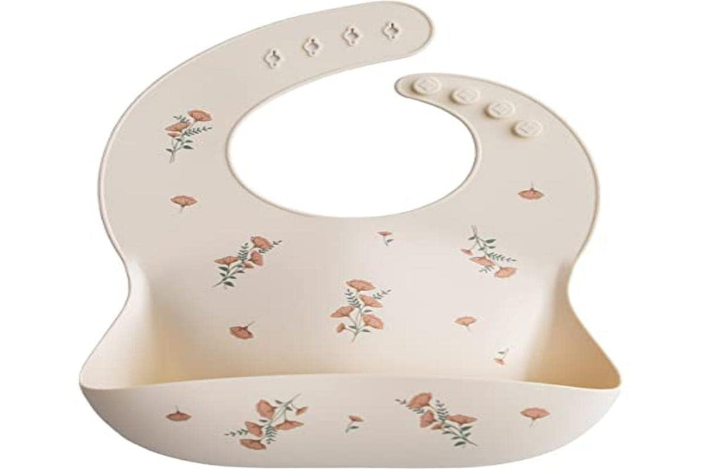 Mushie pink flowers bib demonstrates stain-resistant silicone surface that cleans easily