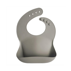 Mushie Silicone Baby Bib Silver Sage with a snug neck-fastener keeps toddlers comfy during meals.