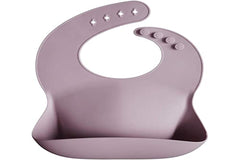 Mushie silicone bib features stain-resistant surface for quick cleanup