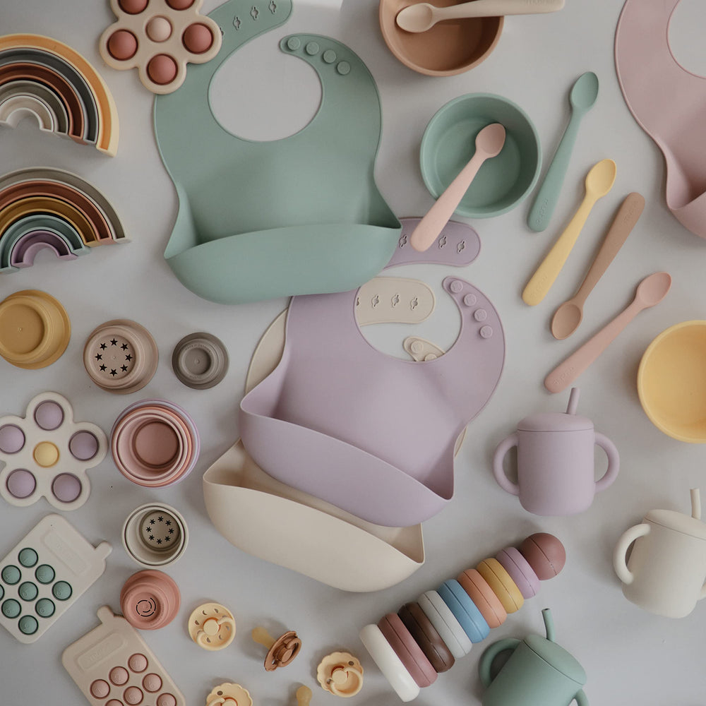 Mushie Sweden-designed bib with timeless pattern complements tableware