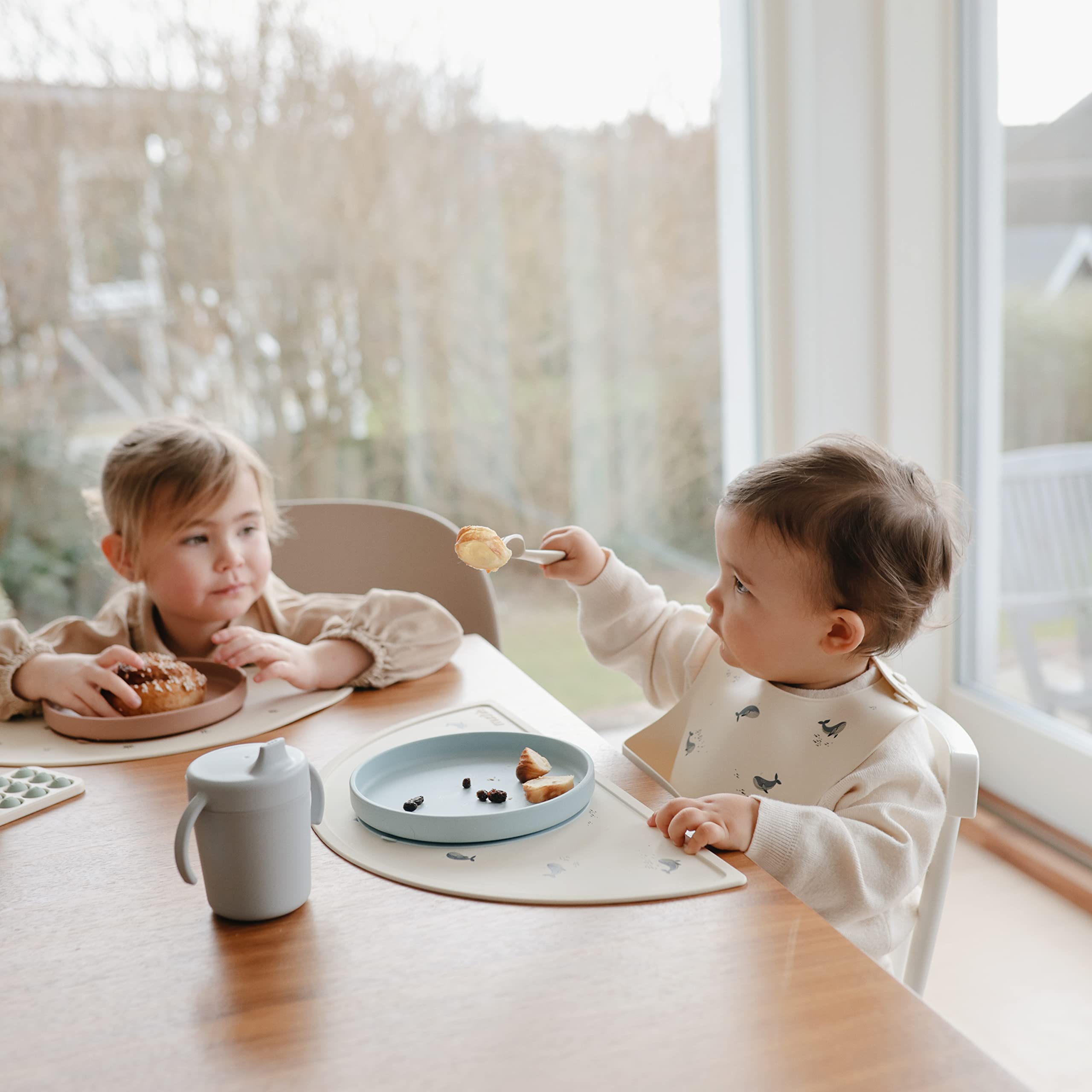 Mushie silicone baby bib waterproof resists water and stains for easy cleanup