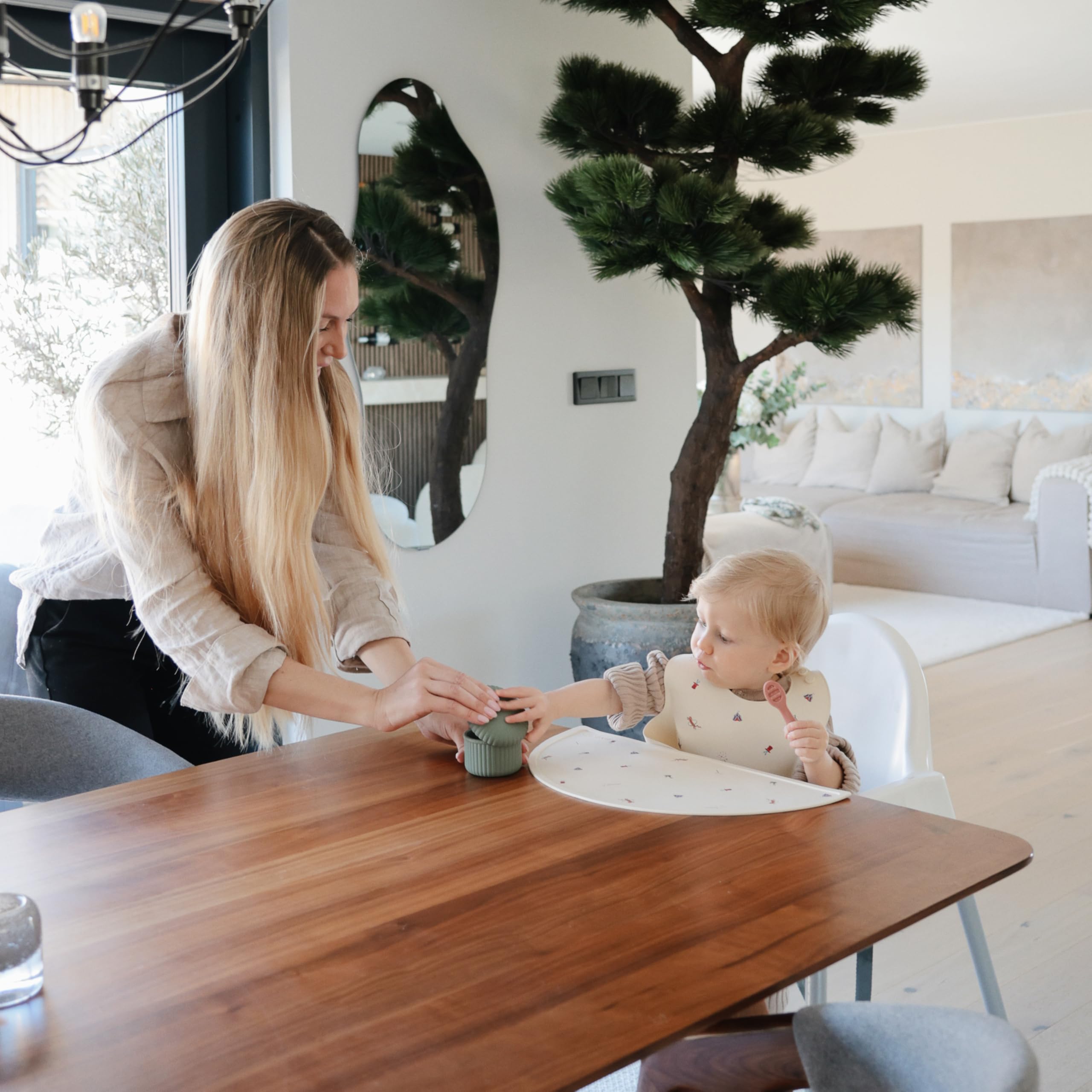 Mushie silicone baby bib is waterproof and BPA-free for safe, wipe-clean mealtimes.