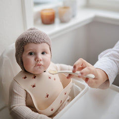 Mushie silicone baby feeding spoons shifting sand handle closeup shows ergonomic grip