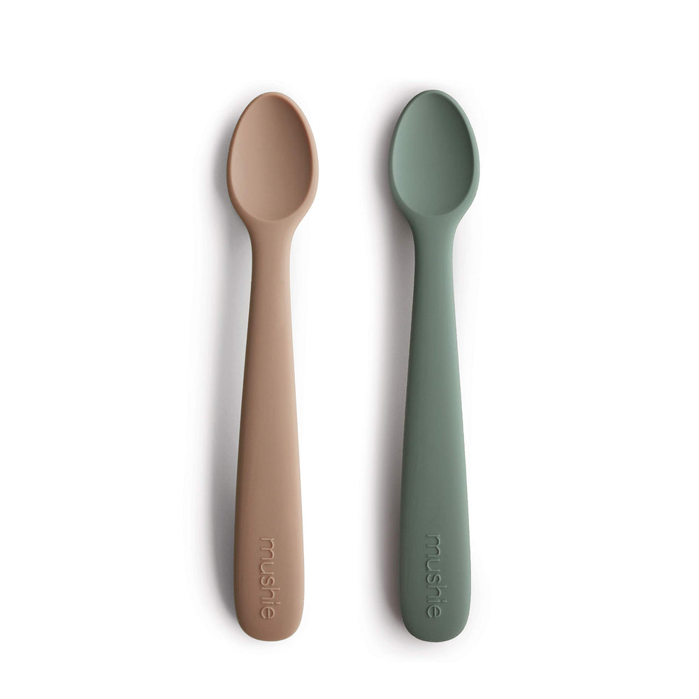 Mushie silicone baby feeding spoons with soft tip protect gums during meals.