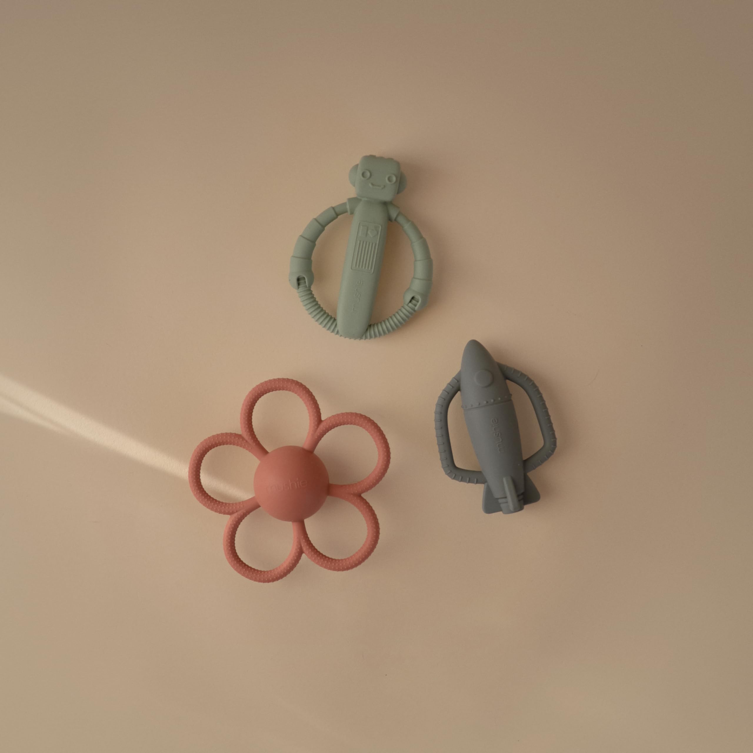 Mushie rocket rattle teether detail with internal rattle for auditory engagement