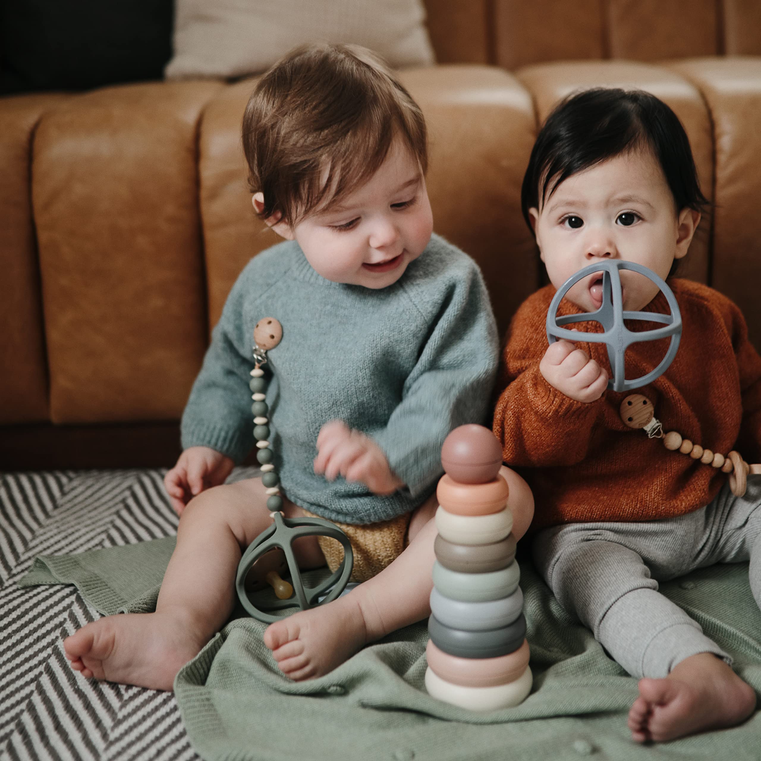 Mushie teether ball with sensory patterns for exploration.