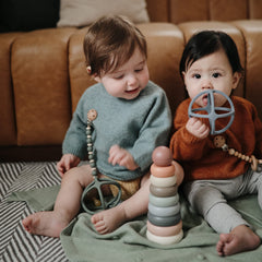 Mushie teether ball with sensory patterns for exploration.