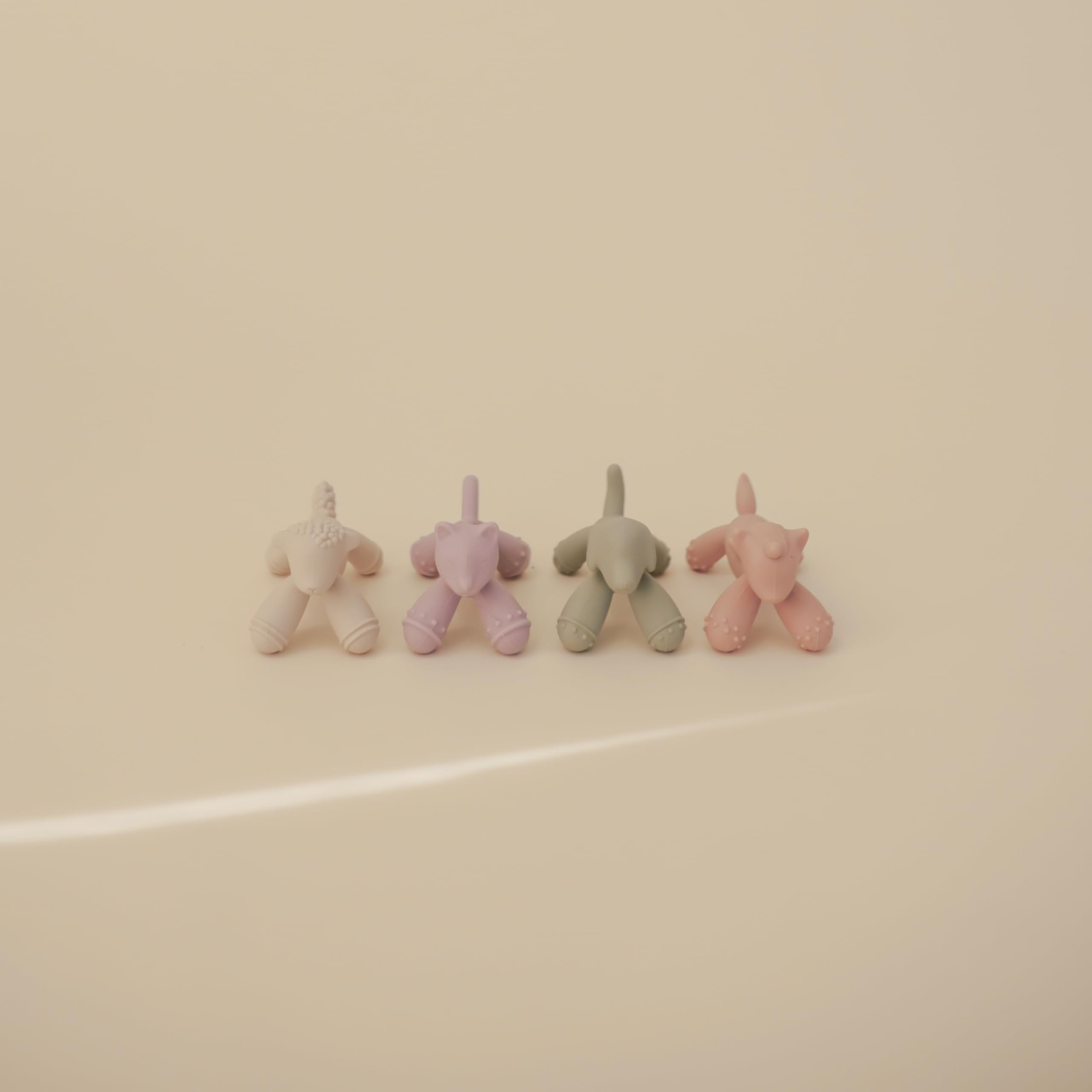 Mushie silicone teether held by tiny hands for on-the-go soothing