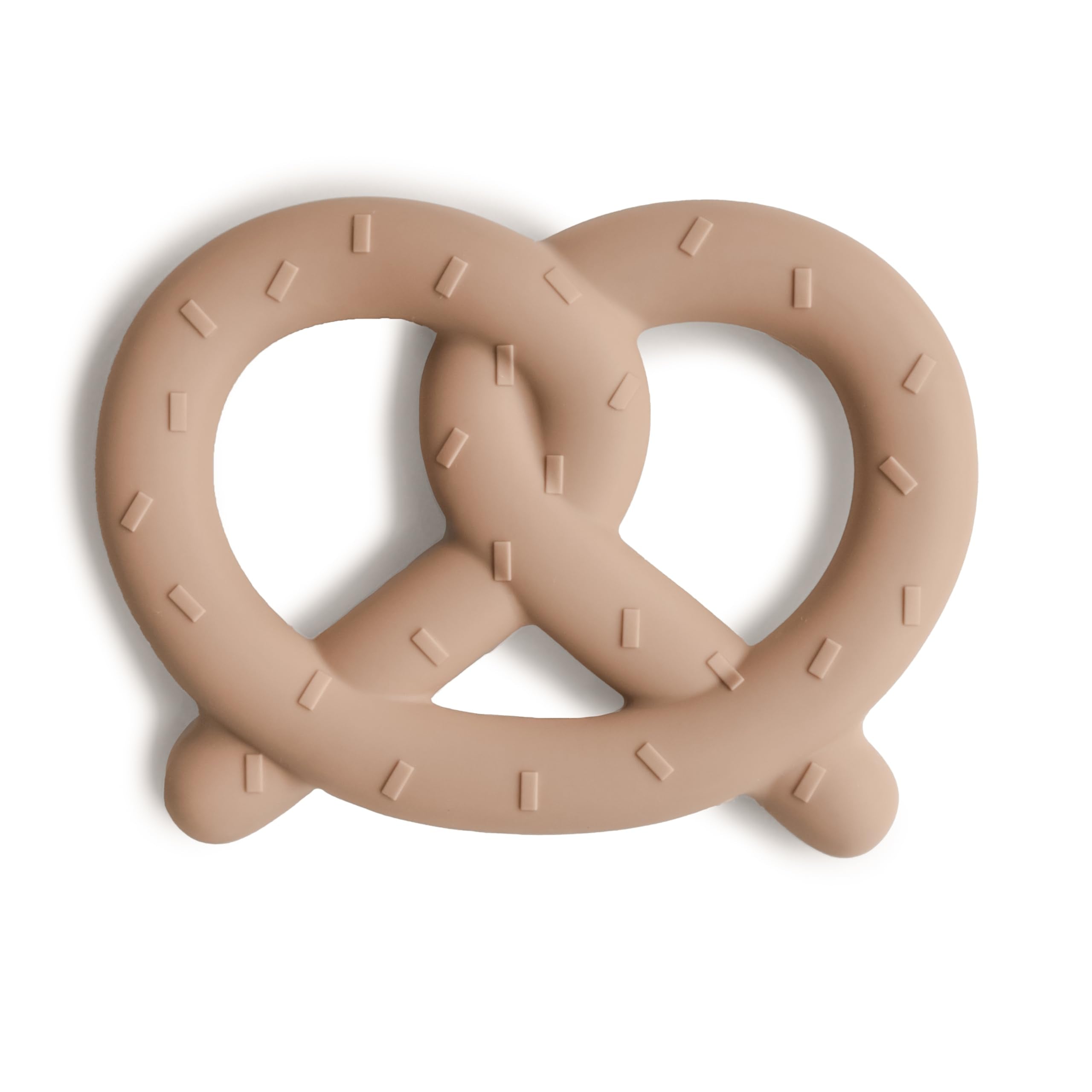 Mushie silicone baby teether pretzel closeup showing soft bite surface for teething relief.