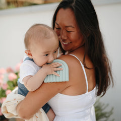 Mushie Rainbow Cambridge Blue teether displayed with stylish design for nurseries