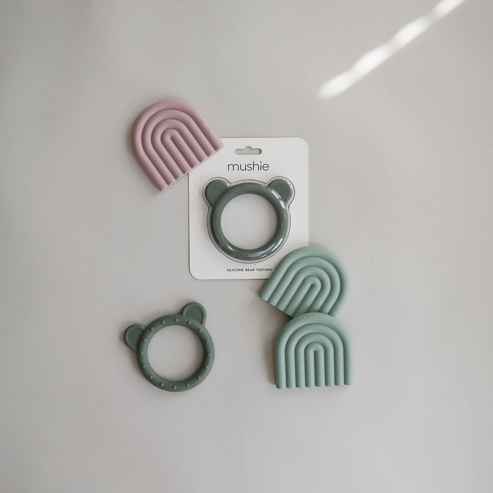 Mushie teether Rainbow Cambridge Blue in hand for comfy grip and safe chewing