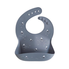 Mushie silicone bib with boats pattern keeps mealtime tidy and stylish.