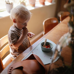 Mushie silicone bib clay adjustable neck-strap worn during feeding for snug fit