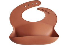 Mushie silicone bib clay wipe-clean closeup showing easy-to-clean surface