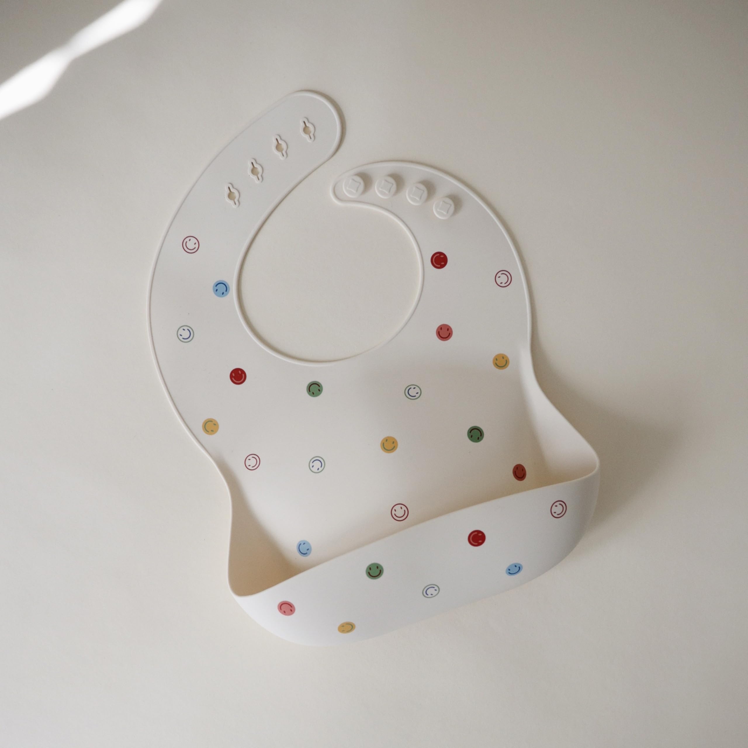 Mushie silicone bib deep pocket catching crumbs and spills