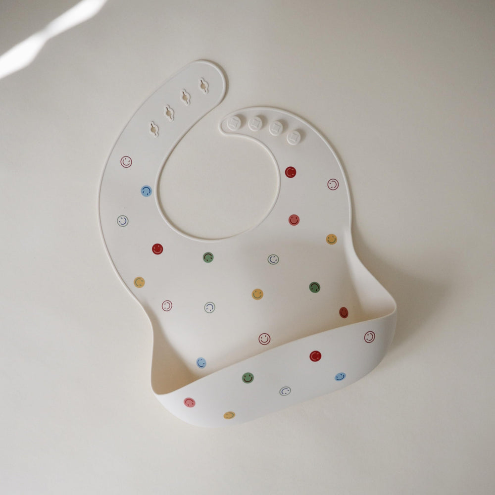 Mushie silicone bib deep pocket catching crumbs and spills