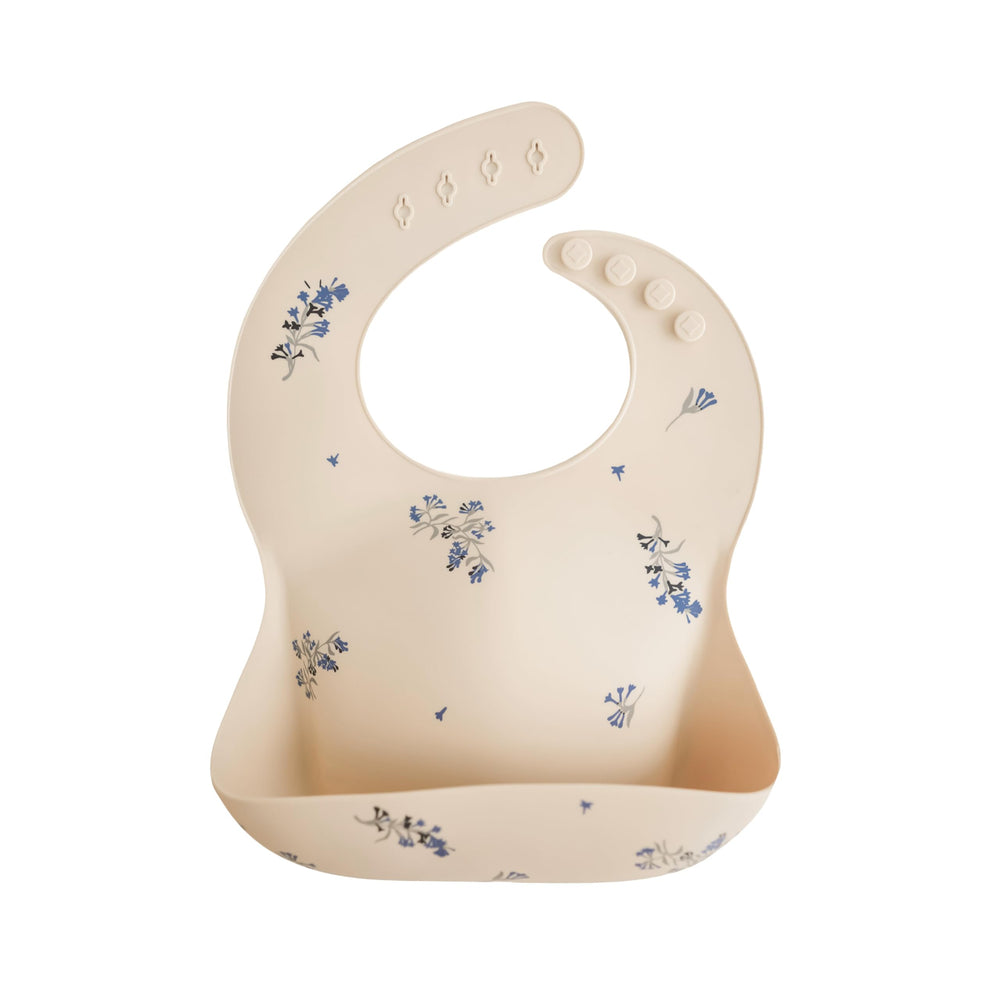 Mushie silicone bib Lilac Flowers front view showing adjustable fit for mess-free meals.