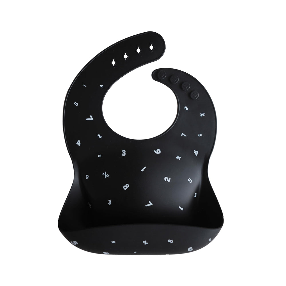 Mushie silicone bib Numbers Black front view shows adjustable fit and easy-clean surface.