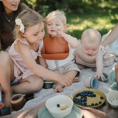 Mushie silicone bib waterproof material allows quick wipe-clean after messes