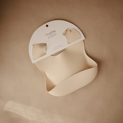 Mushie silicone bib with adjustable neck for a snug growing fit