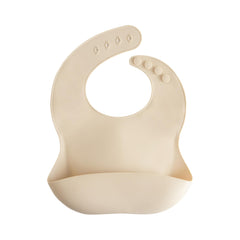 Mushie silicone bib with front pocket designed to catch crumbs during meals