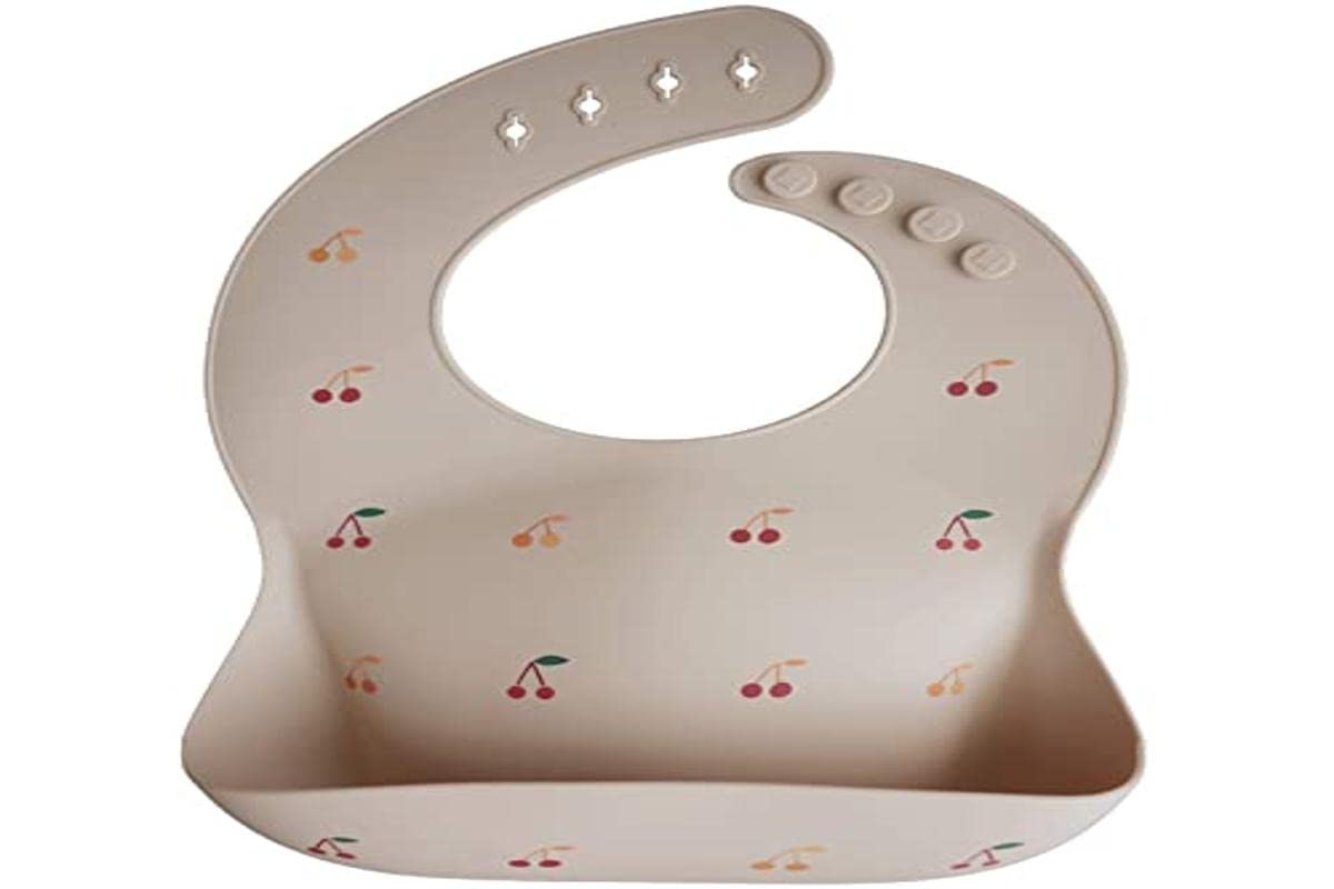 Mushie bib stain-resistant cherries stays bright after mealtime play.