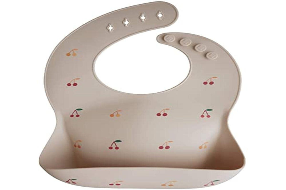 Mushie bib stain-resistant cherries stays bright after mealtime play.