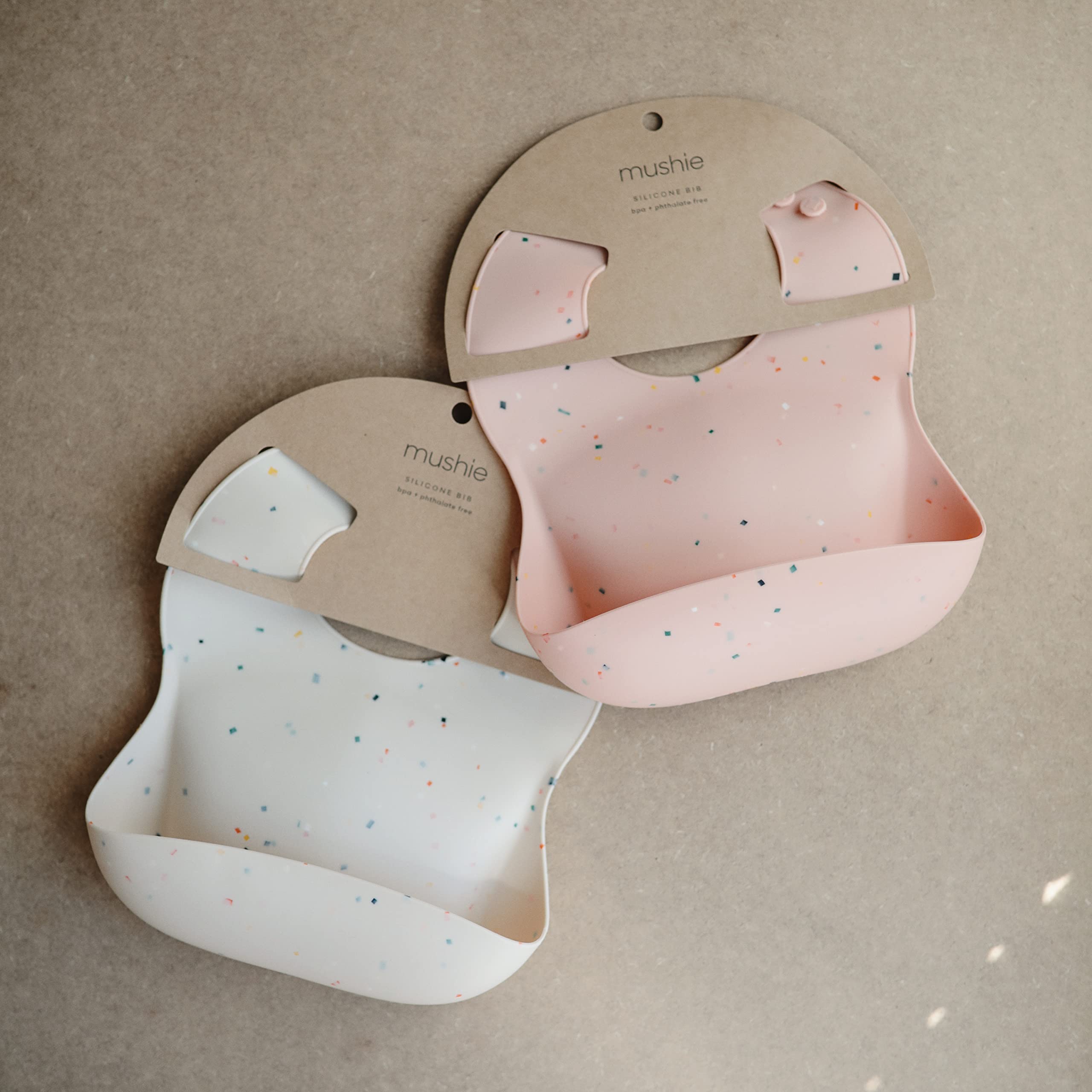 Mushie silicone bib Vanilla Confetti back view demonstrates waterproof, easy-care material.
