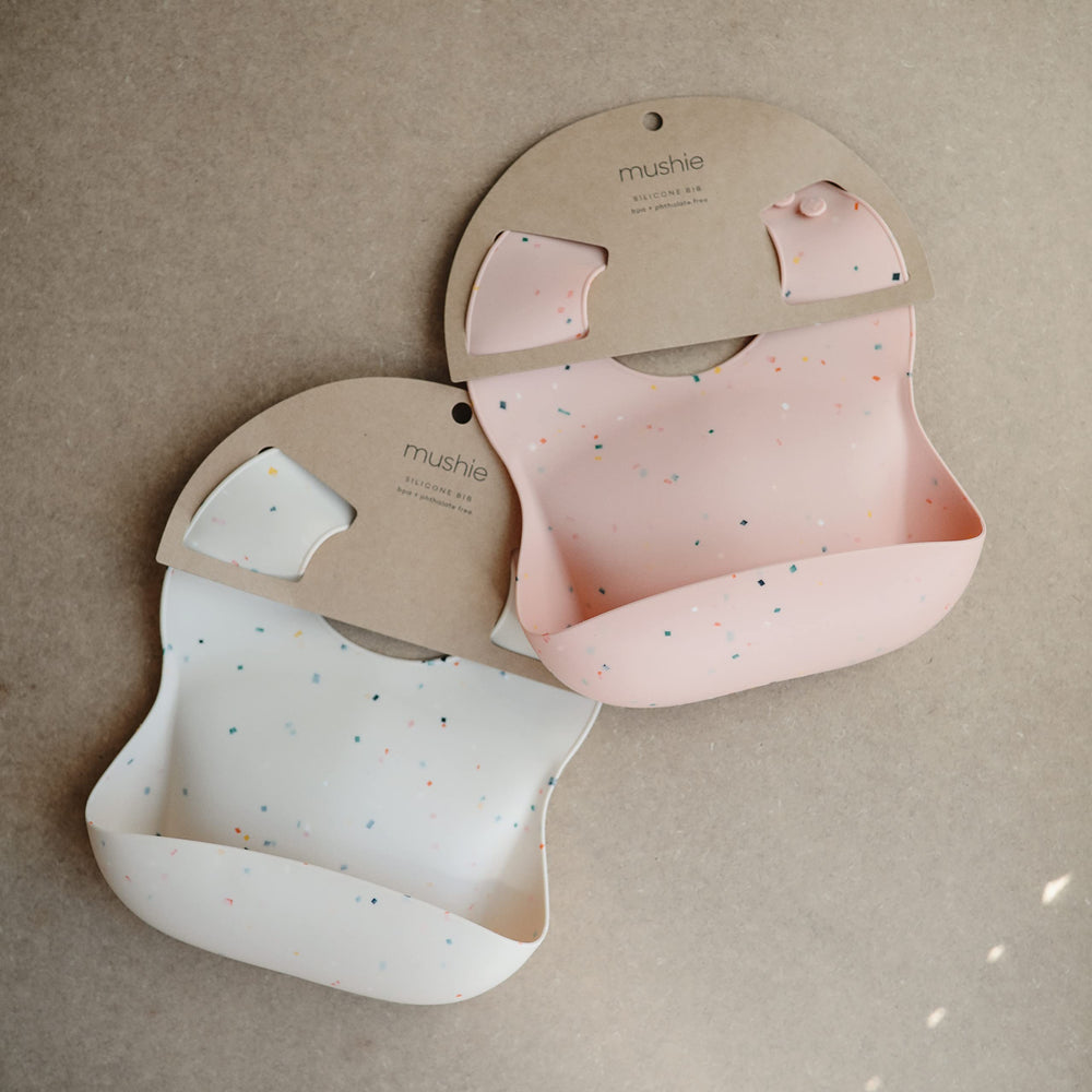 Mushie silicone bib Vanilla Confetti back view demonstrates waterproof, easy-care material.