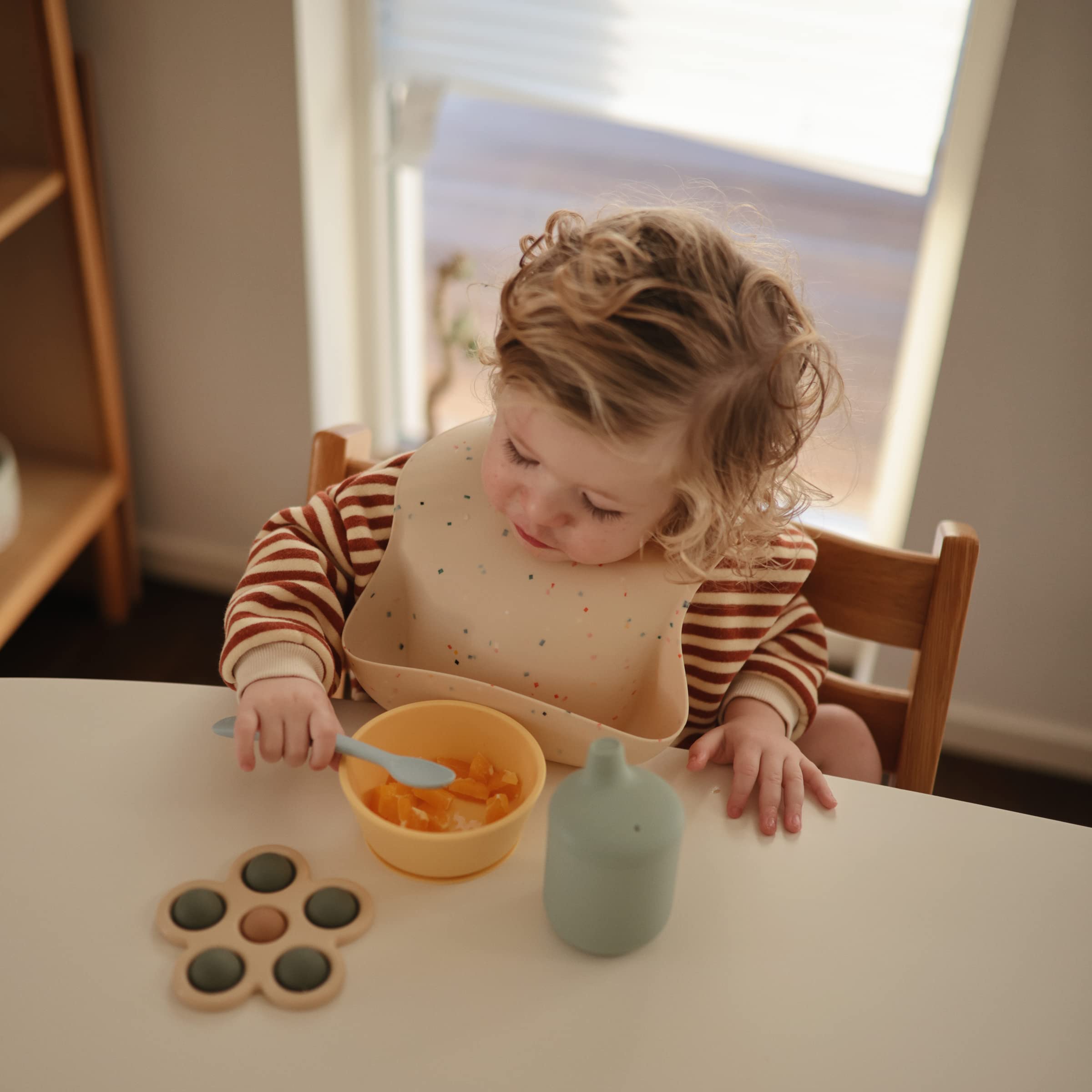 Mushie silicone bib Vanilla Confetti wipe-clean surface simplifies cleanup.