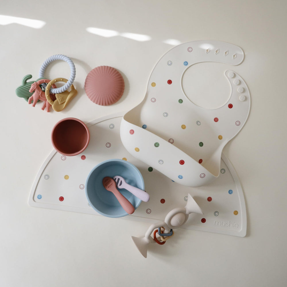 Mushie silicone bib stays waterproof and wipes clean for quick messes