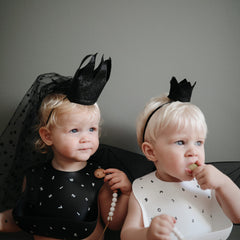 Mushie waterproof silicone bib keeps clothing clean during messy bites