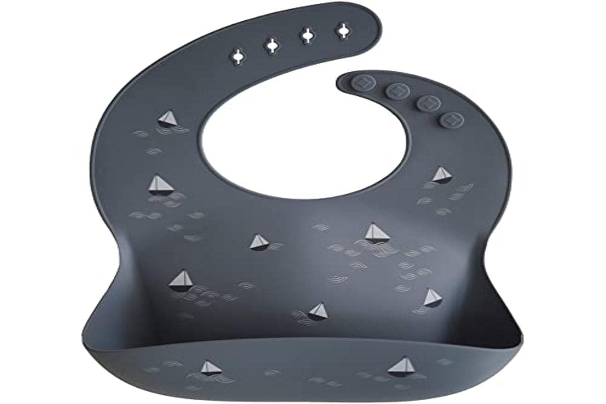 Mushie silicone bib waterproof surface resists spills and wipes clean after meals.