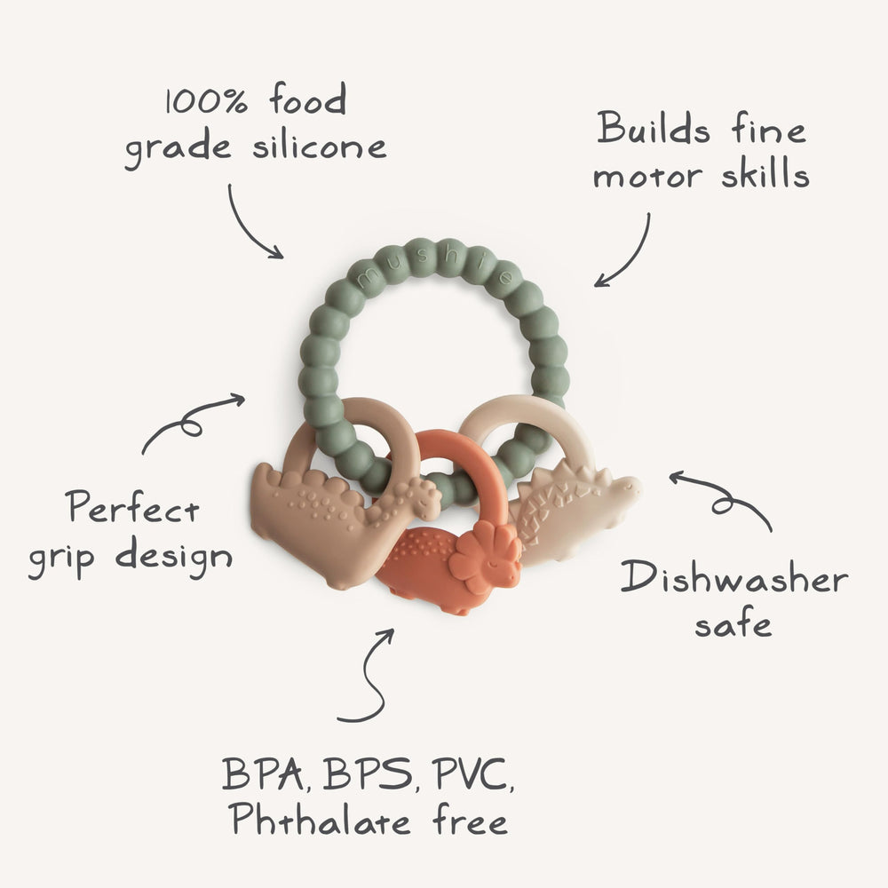 Mushie silicone dino teething ring in use with soft light for calm moments