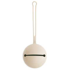 Mushie pacifier holder case in Shifting Sand shows soft silicone texture for on-the-go protection