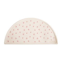 Mushie silicone placemat bows pattern promotes mess-free meals for kids.