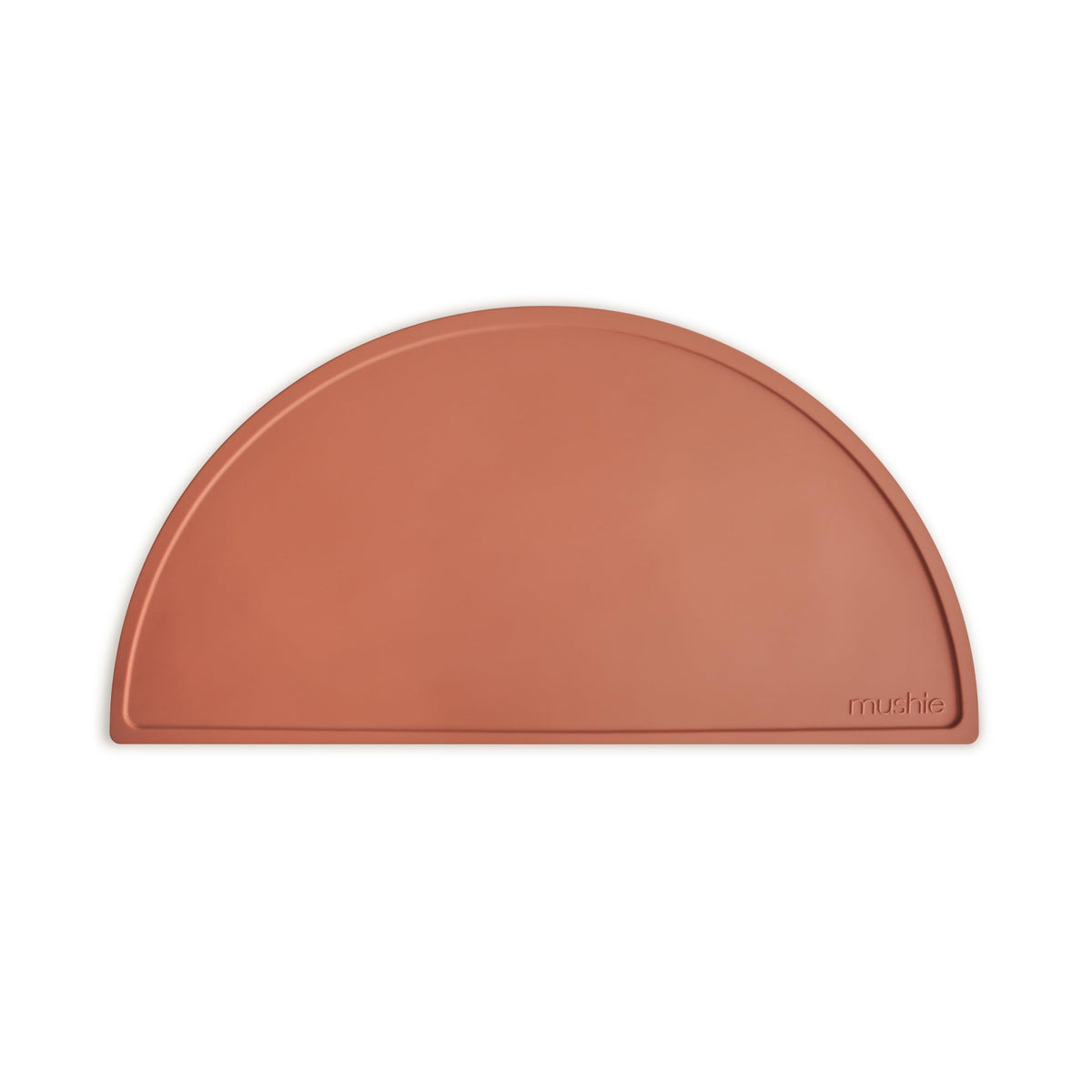 Mushie silicone placemat clay dining mat with non-slip surface for tidy meals.