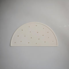 Mushie silicone placemat crowns flatlay shows vibrant design and stain resistance.