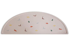 Mushie silicone placemat dinosaurs; easy-clean, water-repellent surface for quick post-meal cleanup.