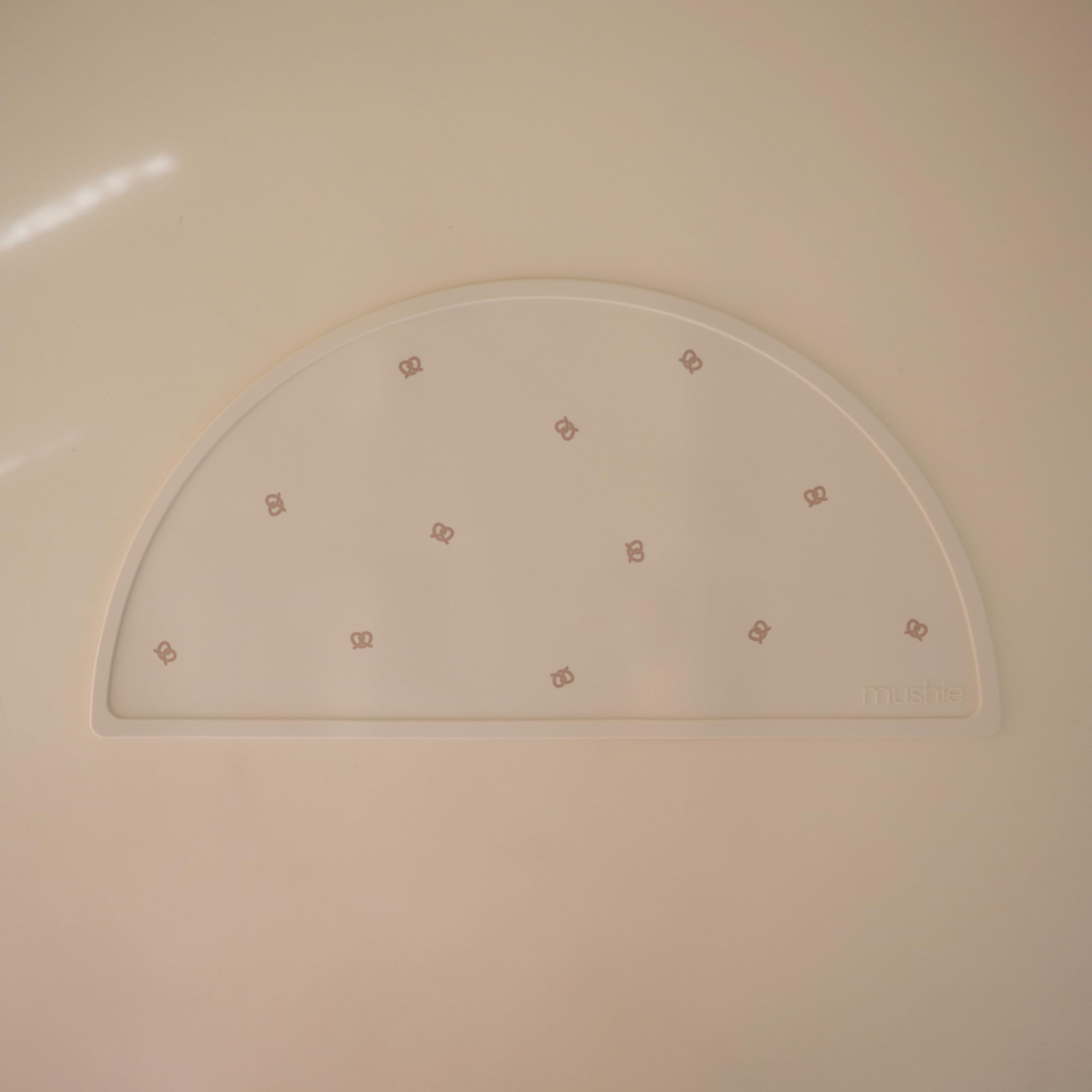 Mushie silicone placemat closeup highlights easy-to-clean, dishwasher-safe surface for busy parents.