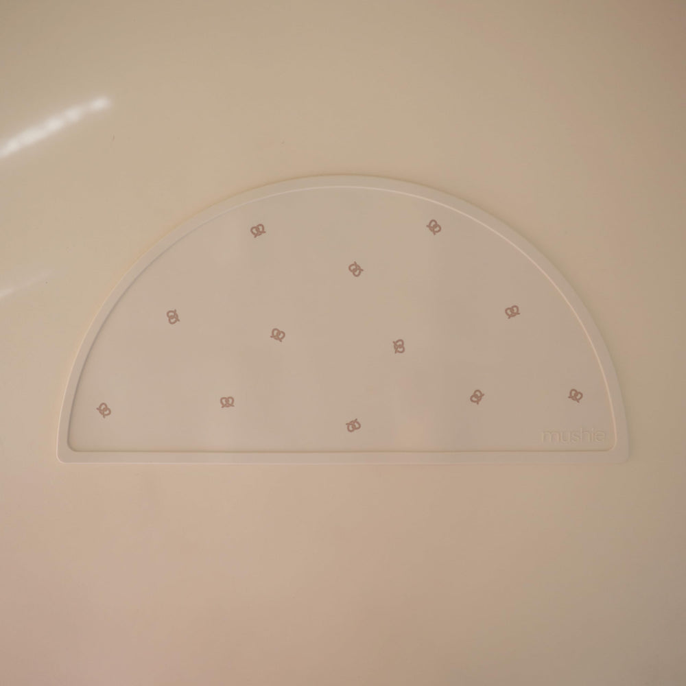 Mushie silicone placemat closeup highlights easy-to-clean, dishwasher-safe surface for busy parents.