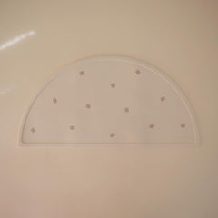 Mushie silicone placemat closeup highlights easy-to-clean, dishwasher-safe surface for busy parents.