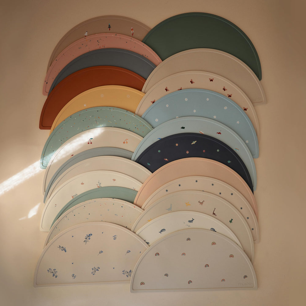 Mushie placemat resists stains and cleans easily after snack time.