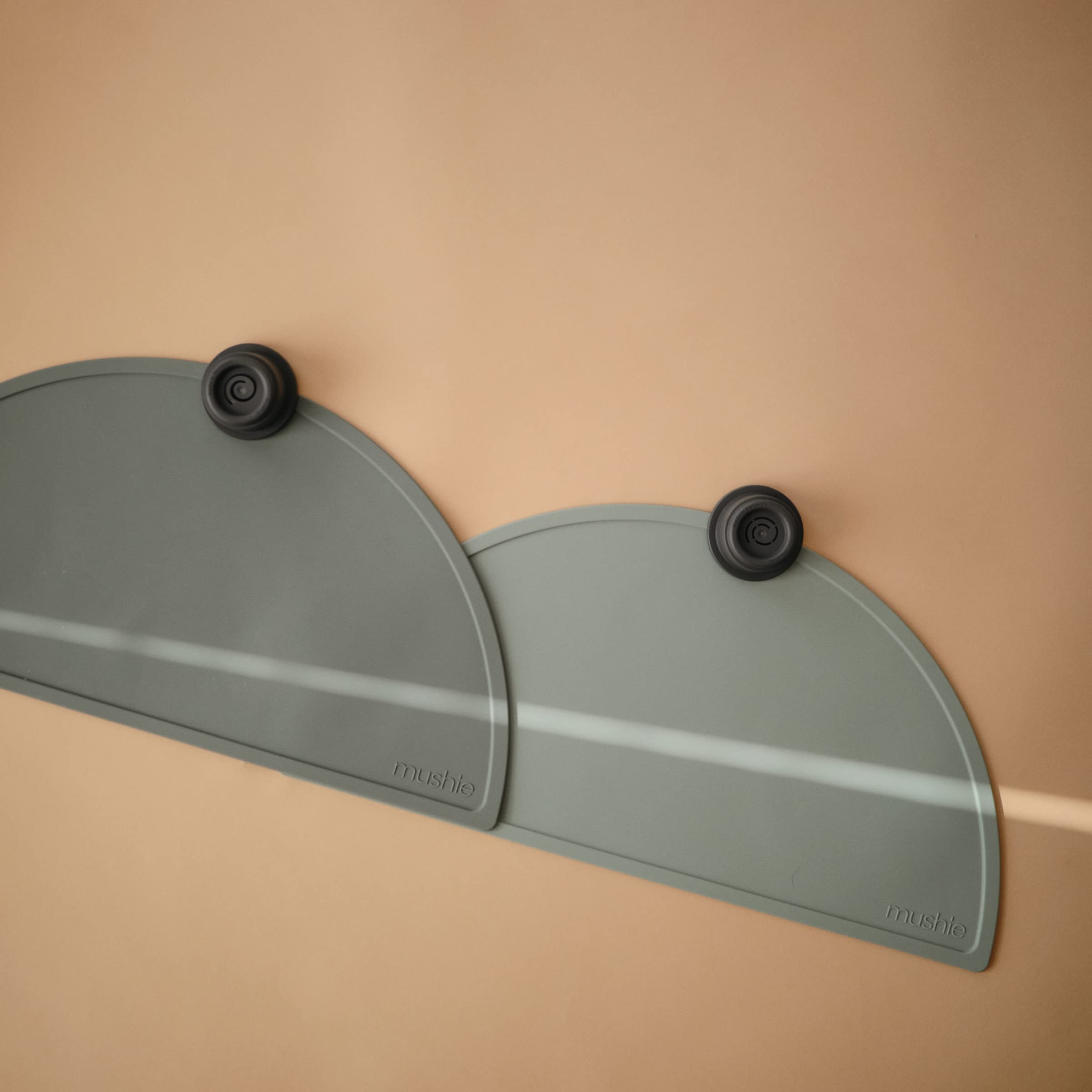 Mushie silicone placemat in dried thyme on a coordinated dining setup enhances mealtime aesthetics.