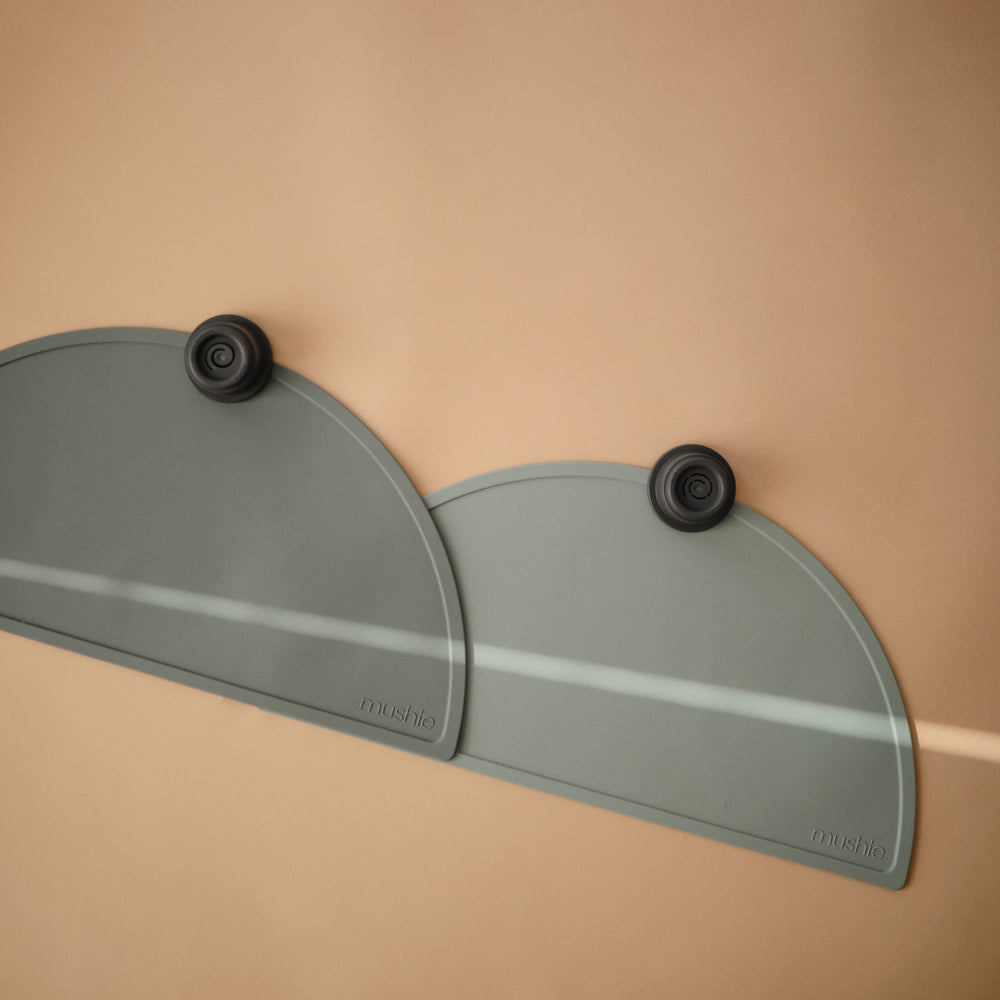 Mushie silicone placemat in dried thyme on a coordinated dining setup enhances mealtime aesthetics.