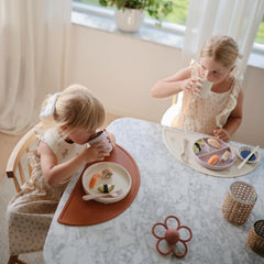 Mushie silicone placemat easy-clean surface resists stains for quick after-meal cleanup.