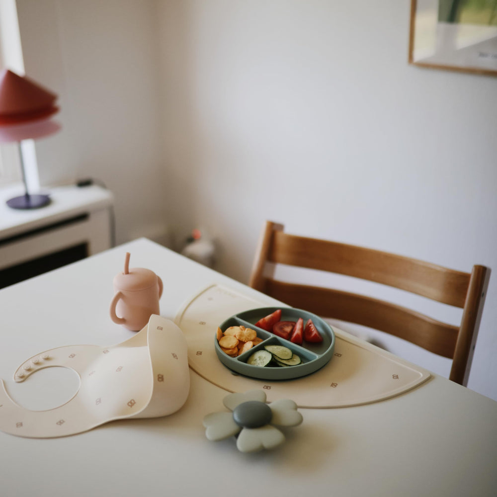 Mushie placemat features kid-friendly design that coordinates with other Mushie products.