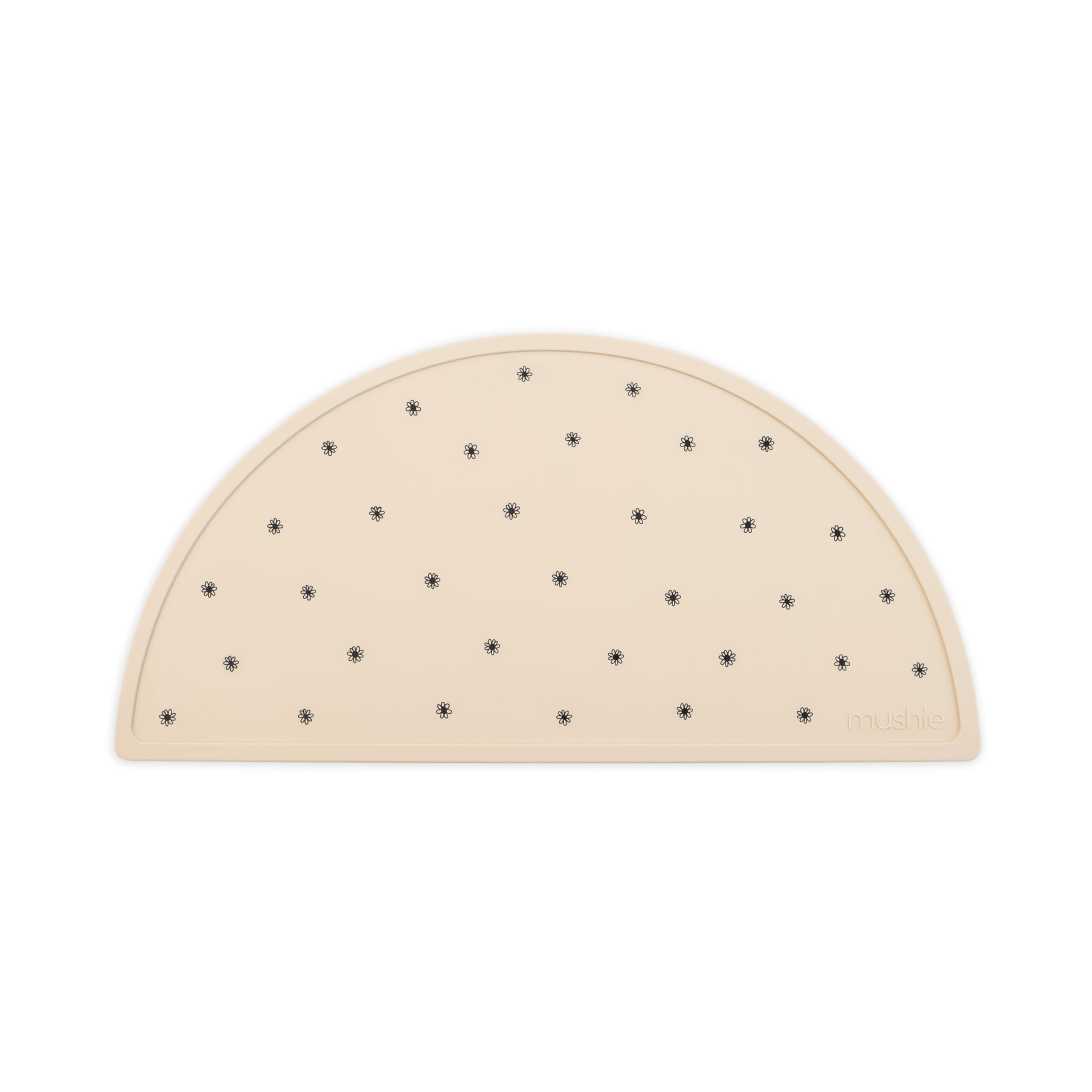 Mushie silicone placemat in Black Daisy keeps meals tidy and stylish at home.