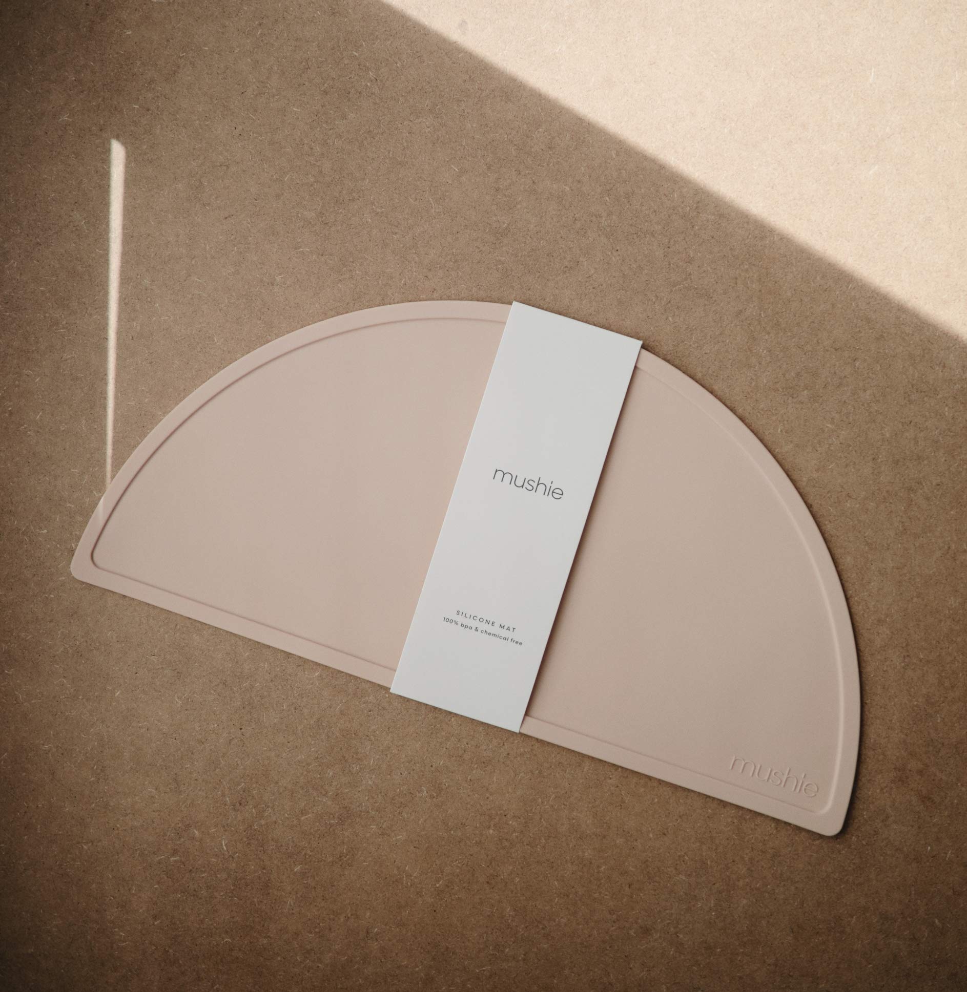 Mushie placemat close-up texture in blush, showing smooth, stain-resistant surface