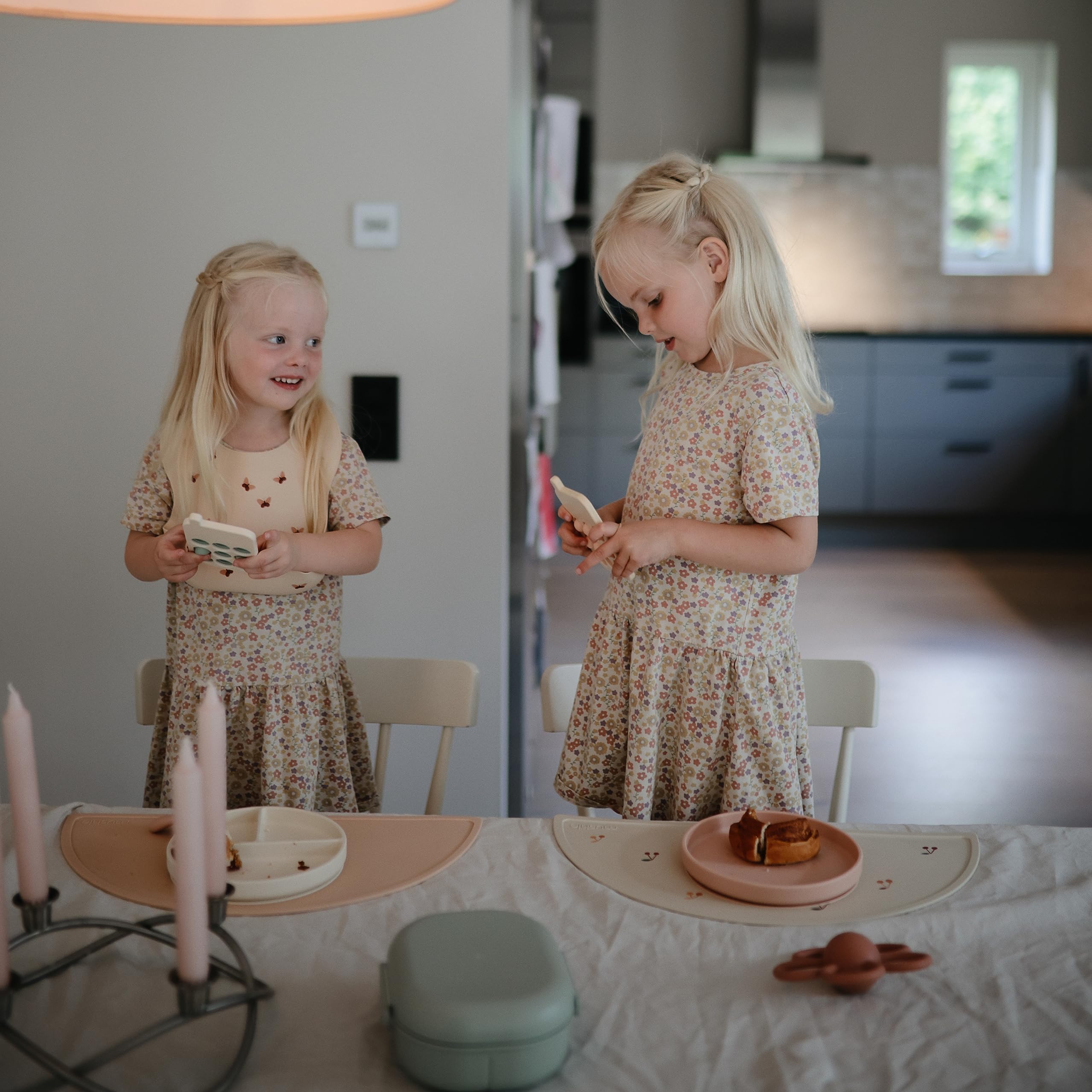 Mushie placemat blush color-variants showing coordinated kitchen look